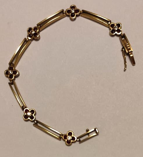 UNA PULSERA ARTICULADA REALIZADA EN ORO KTE 18 CON BRILLANTES Y RUBIES. CIERRE FLOJO CON SEGURO. PESO APROX. 12 GRS. (LAB INF 86531). MEDIDA 17,5 CM DETERIOROS EN GRAL.