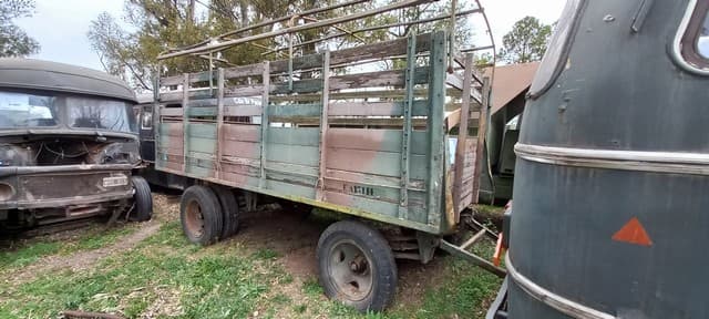 UN ACOPLADO PARA TRANSPORTE DE CARGA (AR) 5T USADO, SIN MARCA, NUMERACIÓN VISIBLE Y AÑO DE FABRICACIÓN. POSEE: ESTRUCTURA DE MADERA Y METAL CON ARCO PORTA LONA, PLATO GIRATORIO, 2 EJES Y 6 RUEDAS ARMADAS CON CUBIERTAS DE MOVIMIENTO. DIMENSIONES APROX. 5MTS. X 2,5MTS. CON DETERIOROS GENERALES, AVERÍAS, DESARMES Y MUY INCOMPLETO. NI 13114.