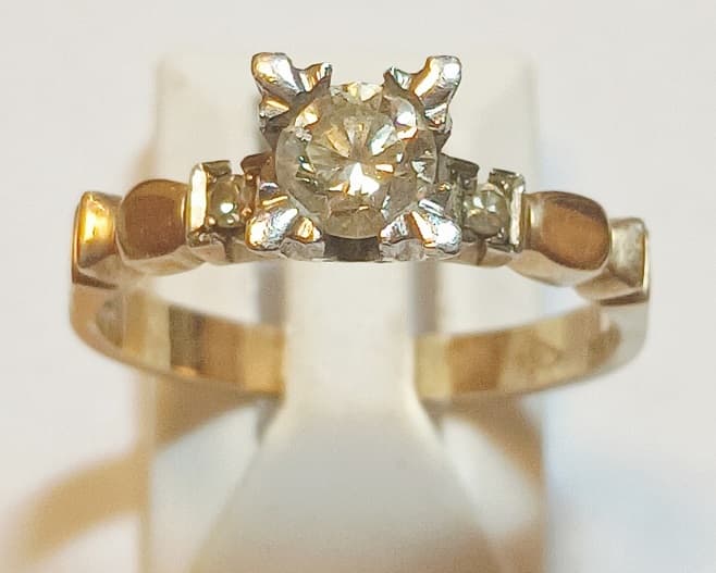 UN ANILLO REALIZADO EN ORO KTE 18 Y PLATINO CON BRILLANTE CENTRAL QTE 0.30 Y BRILLANTES LATERALES 0.04 TOTAL APROX. PESO 4.3 GRS. MEDIDA 16